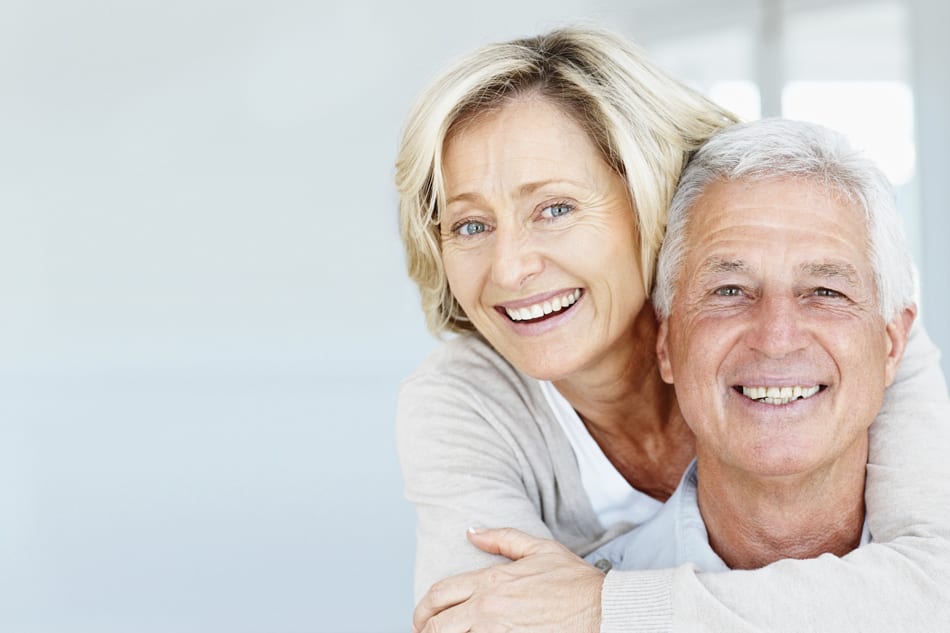 old couple smiling with complete dentures