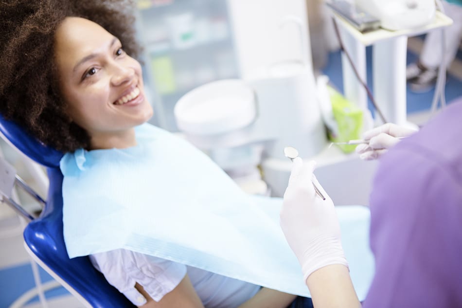 smiling woman sitting up in dentist chair